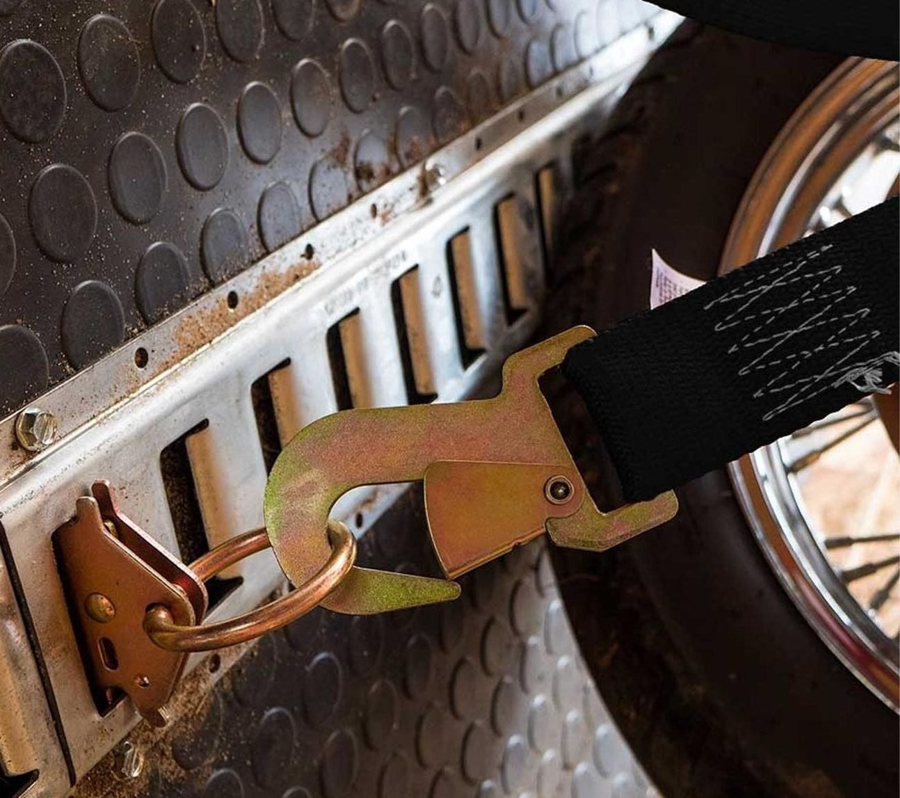 E‑Track rail with ratchet strap securing cargo inside enclosed trailer